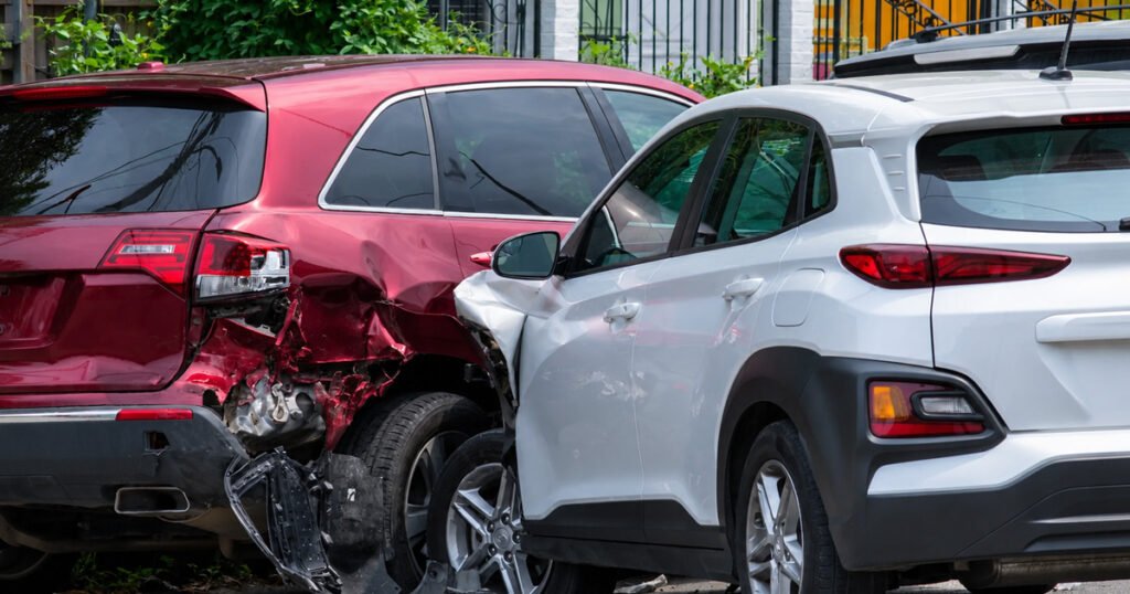 Two SUVs in a T-bone collision with visible side damage on a street.