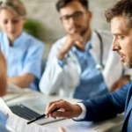 Lawyer explaining document details to medical team in consultation meeting.