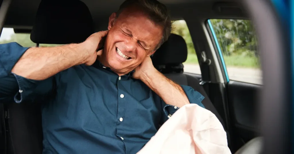 Driver experiencing whiplash pain after car accident